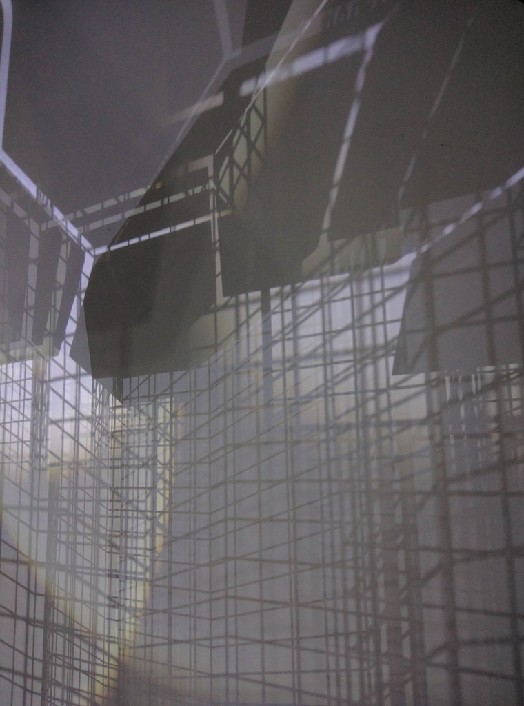 Projected shadows emerge as urban landscape illuminated through high bar table made out of beautiful metal grid structures.